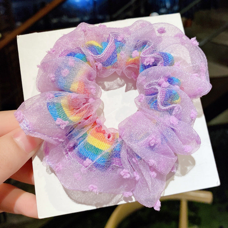 Purple flowers around rainbow scrunchie