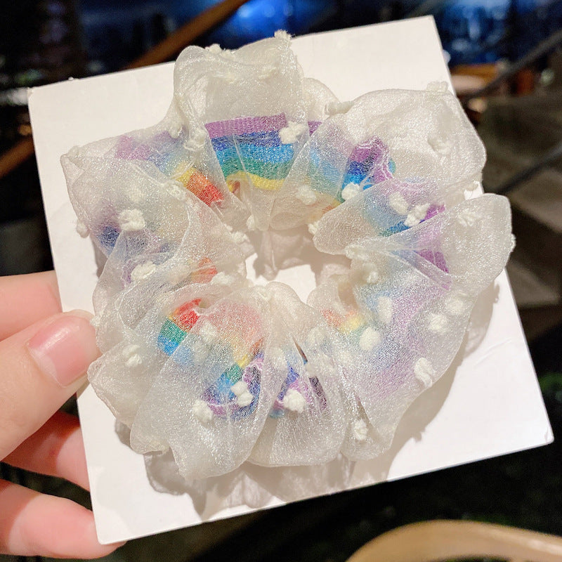 White flowers around rainbow scrunchie